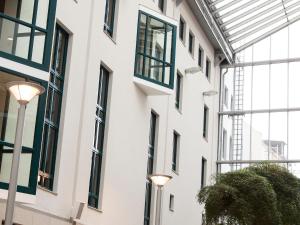 a facade of a building with windows and street lights at My Südstadt Bonn in Bonn