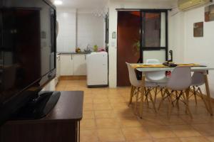 a kitchen with a table and chairs and a television at Ashram in San Miguel de Tucumán