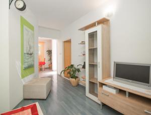 a living room with a flat screen tv on a cabinet at Apartment Raquil in Split