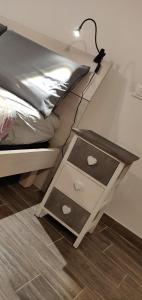a bedside table with two drawers on a bed at Apartments Fewo in Bolzano