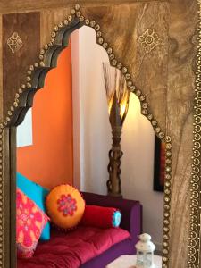 a mirror over a bed in a room at Le Lanterne Resort in Pantelleria