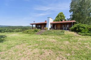 a house on top of a grassy hill at Ellernhof im Spessart in Stadtprozelten
