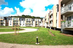 an apartment building with a playground in front of it at Domitys Le Pavillon de Diane in Thionville