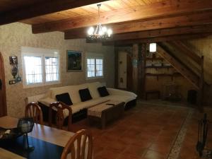 a living room with a couch and a table at Finca San Diego, villa entera para ti in Vallonga