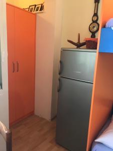 a kitchen with a refrigerator in a room at Apollo - Porat 4 Apartman in Drasnice