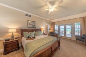 a bedroom with a bed and a ceiling fan at Henderson Park Inn in Destin