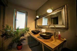 a bathroom with two sinks and a mirror at Enpi Lake Resort in Iaşi +67 photos