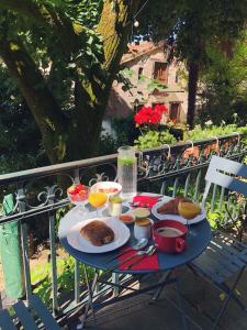 a table with food and drinks on a balcony at Auberge Lion D'Or in Saint-Antonin