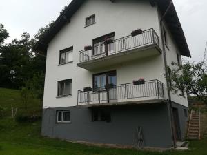 a white building with balconies and flowers on it at Apartments Justin in Bled