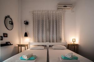 a bedroom with two beds with towels on them at Aggeliki-Smaro Studios in Neos Pirgos