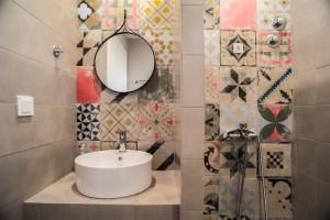 a bathroom with a sink and a mirror at Aggeliki-Smaro Studios in Neos Pirgos +33 photos