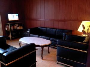 a waiting room with couches and a table and a tv at Hotel Toledano Ramblas in Barcelona