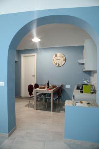 a kitchen with a table and chairs in a room at Patrì House in Catania