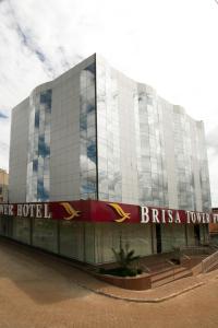 a large glass building with a britania tower at Brisa Tower Hotel in Ceilândia