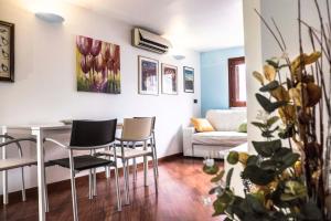 a living room with a table and chairs and a couch at Dream House Duomo Catania in Catania