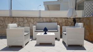 a group of chairs and a table with a vase at Pietra di Luna a...mare in Polignano a Mare