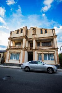 a silver car parked in front of a building at Hotel City Kutaisi in Kutaisi