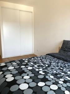 a bedroom with a black and white floor at Sleep in Paris - Pontault in Pontault-Combault