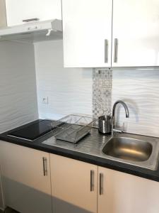 a kitchen with a sink and a counter top at Sleep in Paris - Pontault in Pontault-Combault