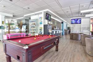 a pool table in a billiard room with at Bayside Salgados in Albufeira