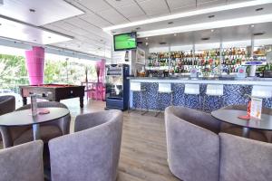 a restaurant with two tables and a bar with a pool table at Bayside Salgados in Albufeira