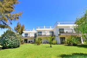 an apartment building with a lawn in front of it at Bayside Salgados in Albufeira