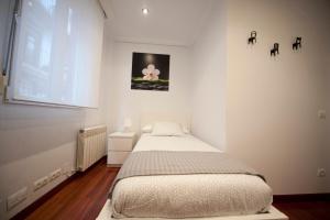 A bed or beds in a room at Calle Río de la Pila