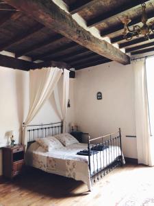 a bedroom with a bed and a wooden floor at Auberge Lion D'Or in Saint-Antonin