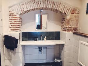 a bathroom with a sink and a mirror at Auberge Lion D'Or in Saint-Antonin-Noble-Val