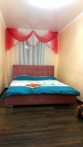 a bedroom with a bed with a pink curtain at Apartments in the Center of the city in Dnipro