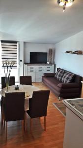 a living room with a table and a couch at Apartmani Tatić Štinjan in Štinjan