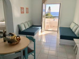 a living room with a table and a room with a view at Liofoto Sea View Apartments in Stalida