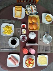 a table with plates of food on a table at Libertad Hotel in Trujillo