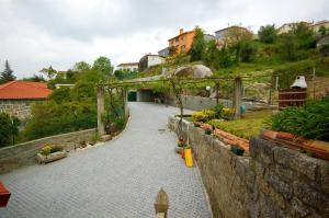 a stone walkway leading down a hill with houses at Casa da Ramada - Water SPA Tank with running natural spring water - by Bedzy in Braga