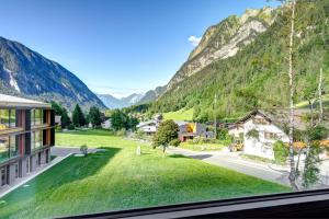 a view from a window of a village with mountains at Hotel Lün in Brand