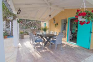 eine Terrasse mit einem Holztisch und Stühlen darauf in der Unterkunft Villa Mare in Nerezine