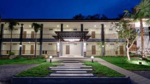 an exterior of a building at night at Myrrh Hotel Chanthaburi in Chanthaburi