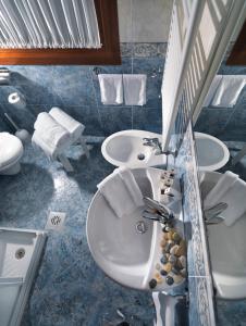 a bathroom with a sink and a toilet at Hotel & Residence Roma in Camposampiero