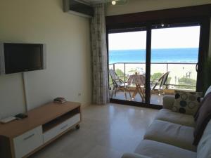 a living room with a couch and a view of the ocean at The Apartment in Gran Tarajal