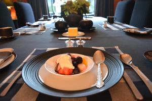 a table with a bowl of food on a plate at Scaurbridge House in Thornhill