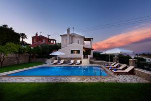 a house with a swimming pool in the yard at Tesori Dassia Villas By Hotelius in Dassia
