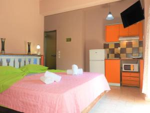a bedroom with a bed with two towels on it at Zako Apartments in Limenaria