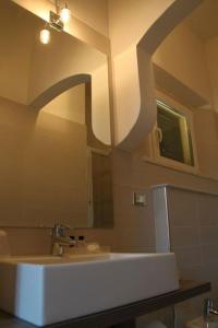 a bathroom with a sink and a mirror at Il Viale b&b in Pontedera
