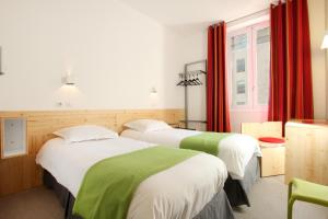 Säng eller sängar i ett rum på Hôtel Hermès