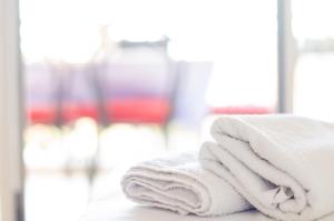 a stack of towels on a counter in a bathroom at Apartmani Šutić in Promajna +278 photos