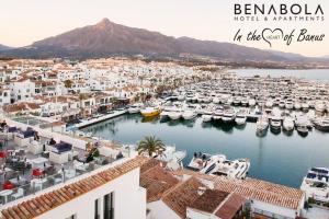 a city with a lot of buildings and a lake at Benabola Hotel & Suites in Marbella
