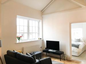 a living room with a couch and a bed at No 3 Old Printworks in Winchester