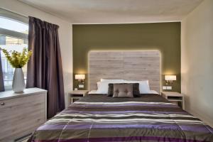 Postel nebo postele na pokoji v ubytování Il Palazzin Hotel
