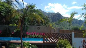 a garden with a bench and flowers and mountains at Sierra Central By Chic Hotel Group in Tepoztl&aacute;n
