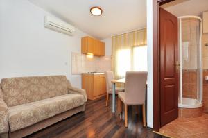 a living room with a couch and a table at Apartment House Jerko in Kaštela